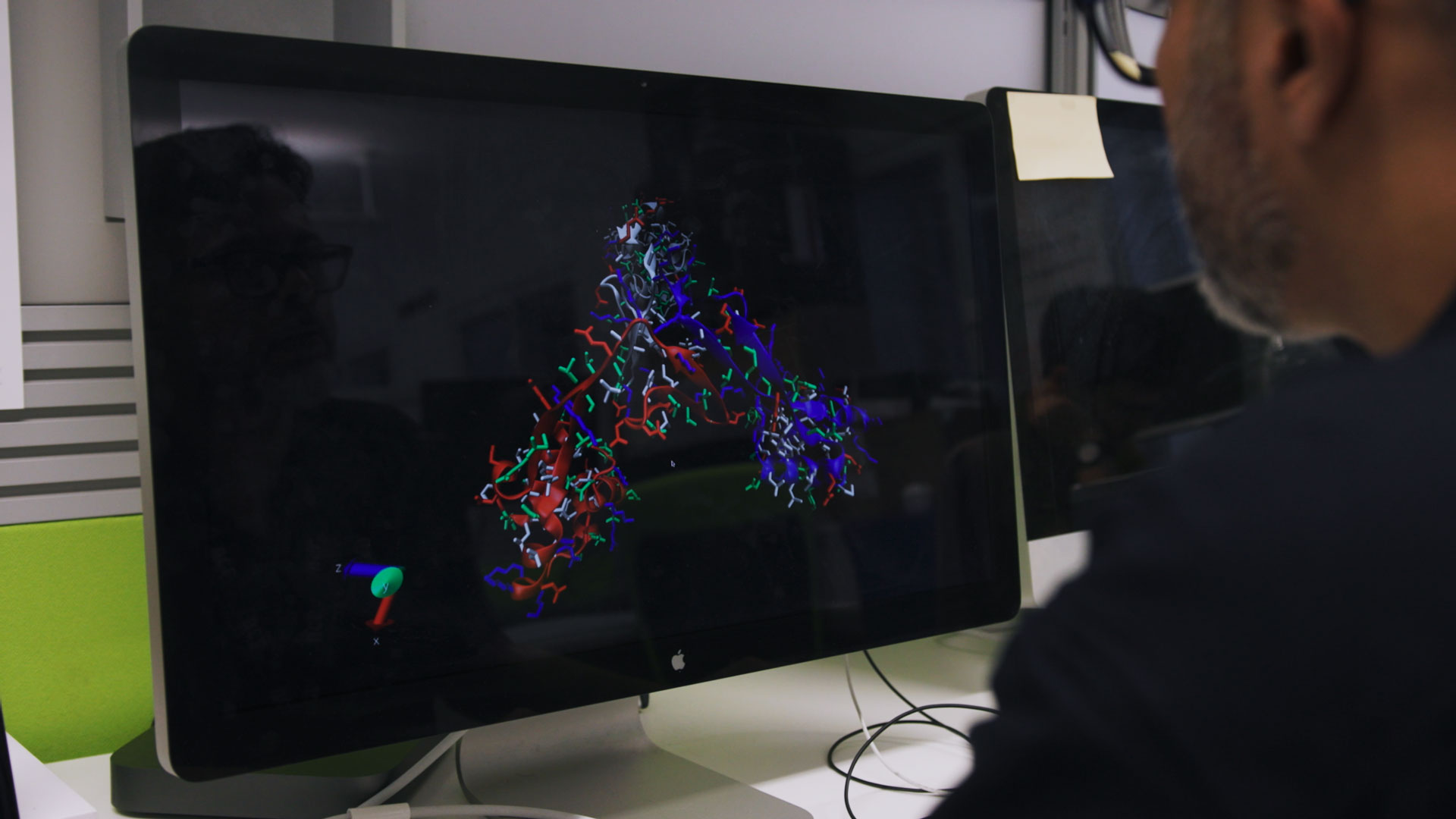 A researcher performing data analysis on a computer, showcasing technical academic research storytelling.